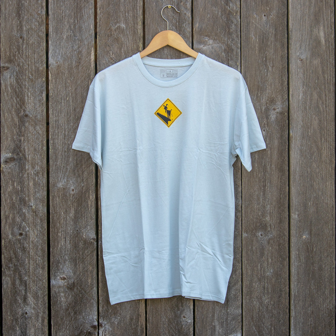 Blue shirt with goats on the roof logo