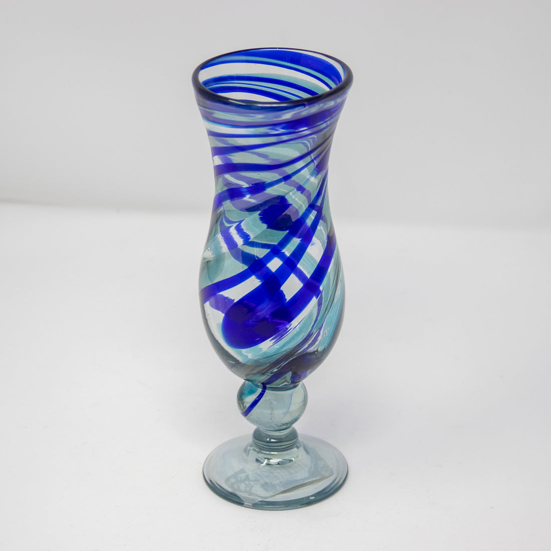Pina colada glass with a blue swirl design viewed from above
