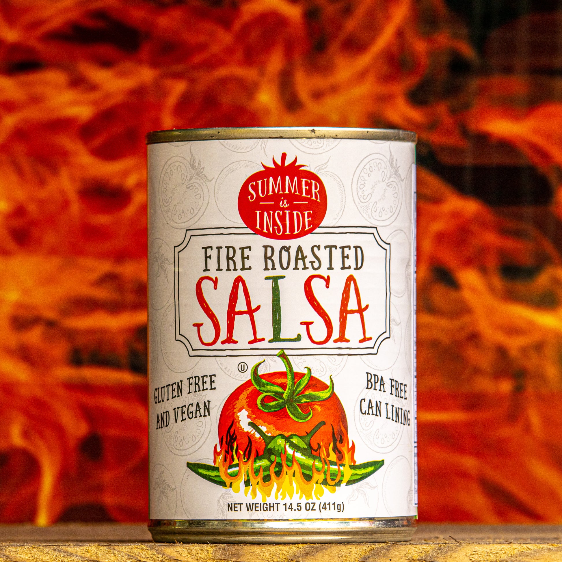 A can of fire roasted salsa in front of painting of flames